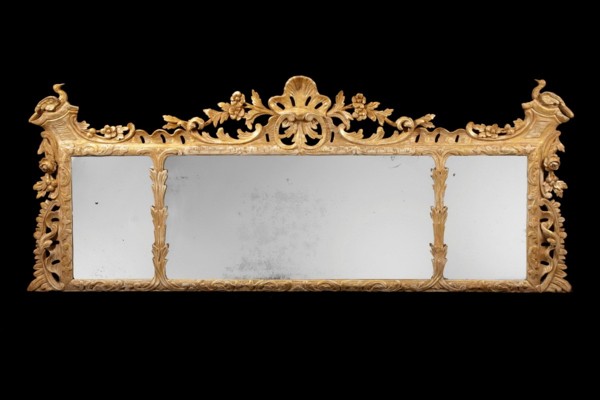 A rare early 18th century carved giltwood overmantle mirror.