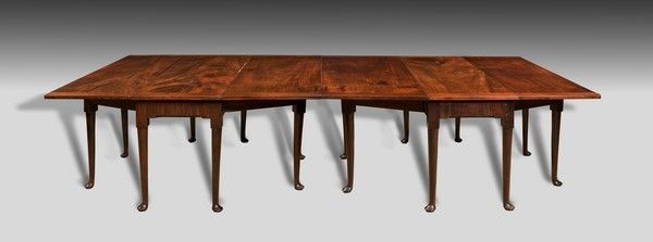 A particularly rare George II period mahogany twin drop leaf dining table.
